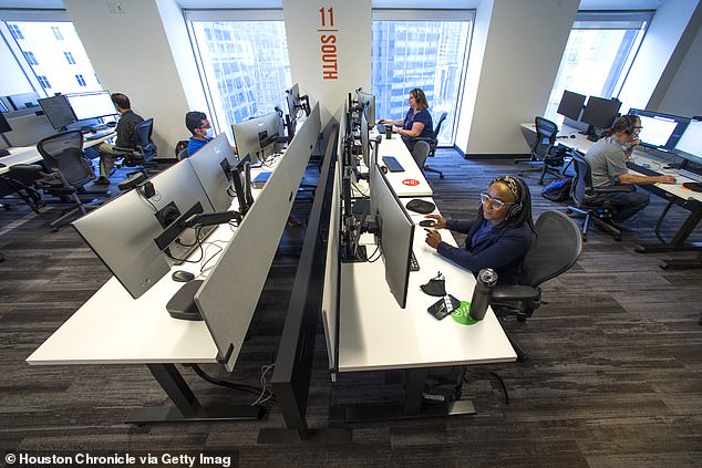 In a survey of 1,000 business leaders in the US, ResumeBuilder.com found that 96 percent of respondents working at companies with a remote or hybrid workforce said their company used some form of employee monitoring software.  Pictured: Employees work on the sports-themed 11th floor of the JPMorgan Chase office at 600 Travis, Tuesday, September 7, 2021 in Houston