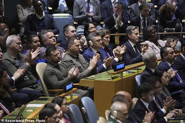 Ukrainian President Volodymyr Zelensky applauds as President Joe Biden accuses Russia of the war in Ukraine during his speech to the United Nations General Assembly on Tuesday