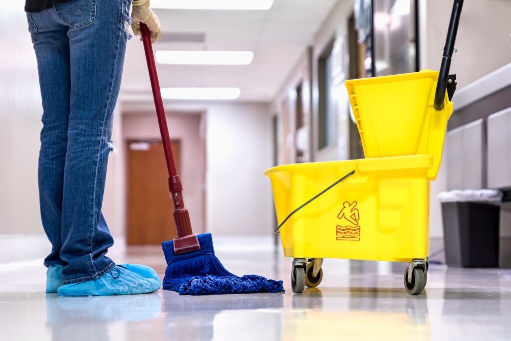 mopping wet floor in hallway