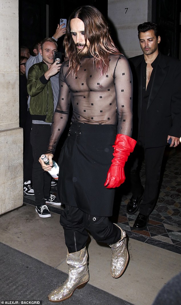 The actor - who recently showed off his fit figure at a Paris Fashion Week show - paired his sheer top with a jet black wrap skirt worn over matching trousers