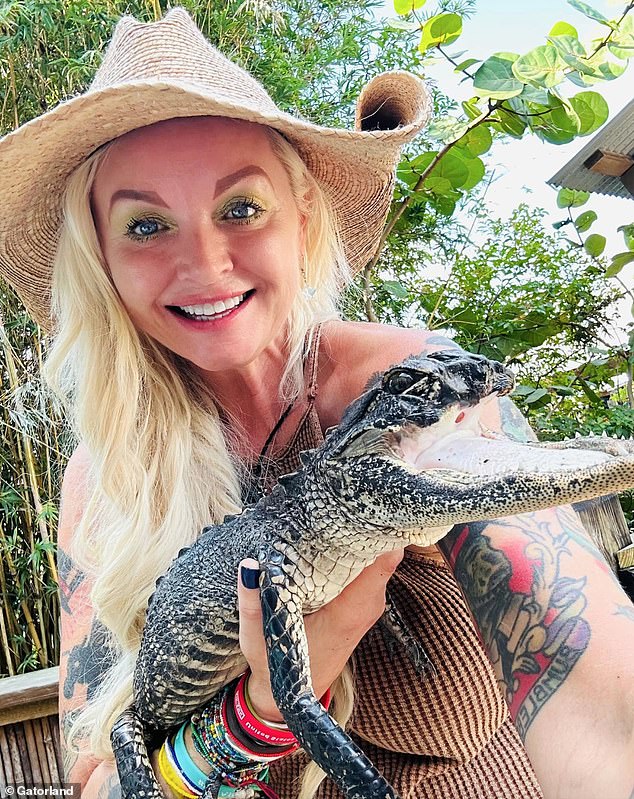 Gatorland's global conservation ambassador, Savannah Boan, helps care for the alligator