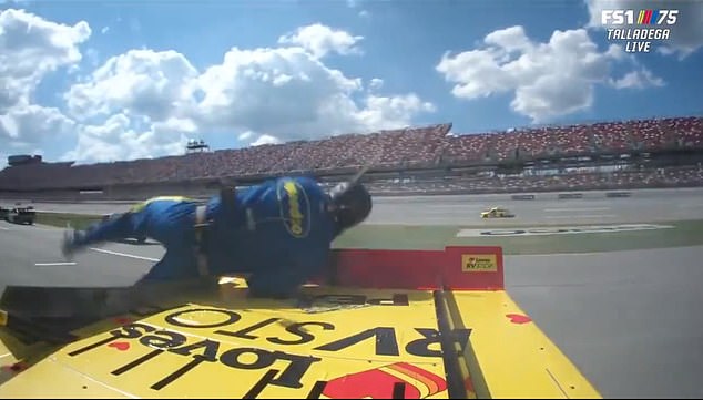 A camera angle from the car shows Plank fully stepping onto the truck and sending it into the air