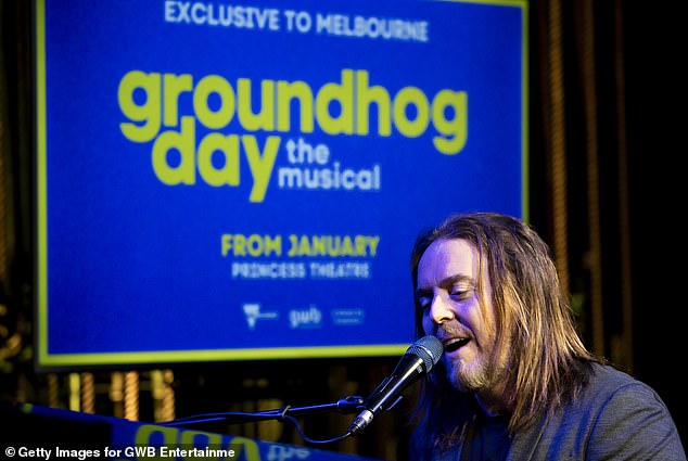 At one point he sat down on a stool in front of a piano and played his favorite instrument, in front of a poster announcing the musical was heading to Melbourne.