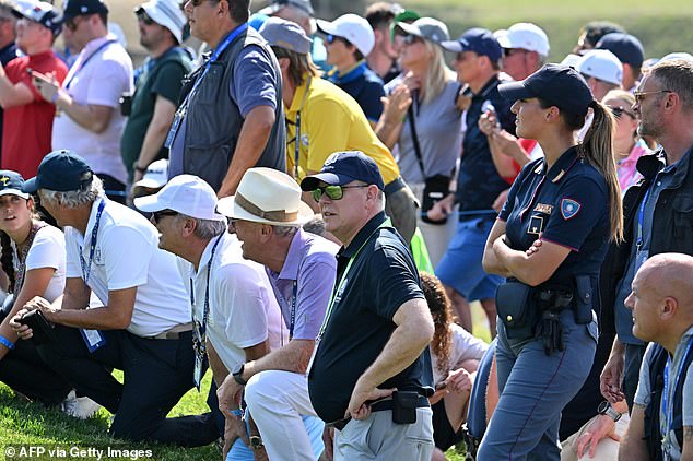 He also wore a navy blue polo shirt and dark reflective sunglasses, in addition to smart gray trousers