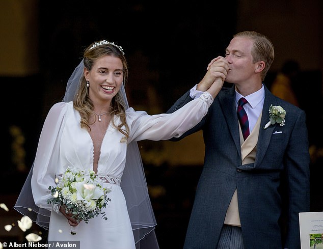 Both the bride and groom appeared to be beaming, with the Archduke even raising his new wife's hand to kiss his new wife at one point after the ceremony