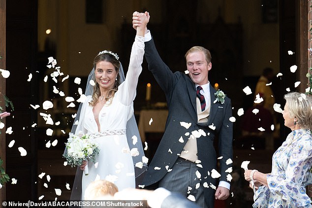 MAN AND WOMAN: The couple appears both happy and triumphant as they leave the church hand in hand