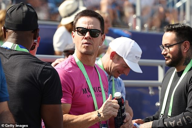 Toned down: The 52-year-old actor opted for a form-fitting pink T-shirt, which showed off his impressive triceps