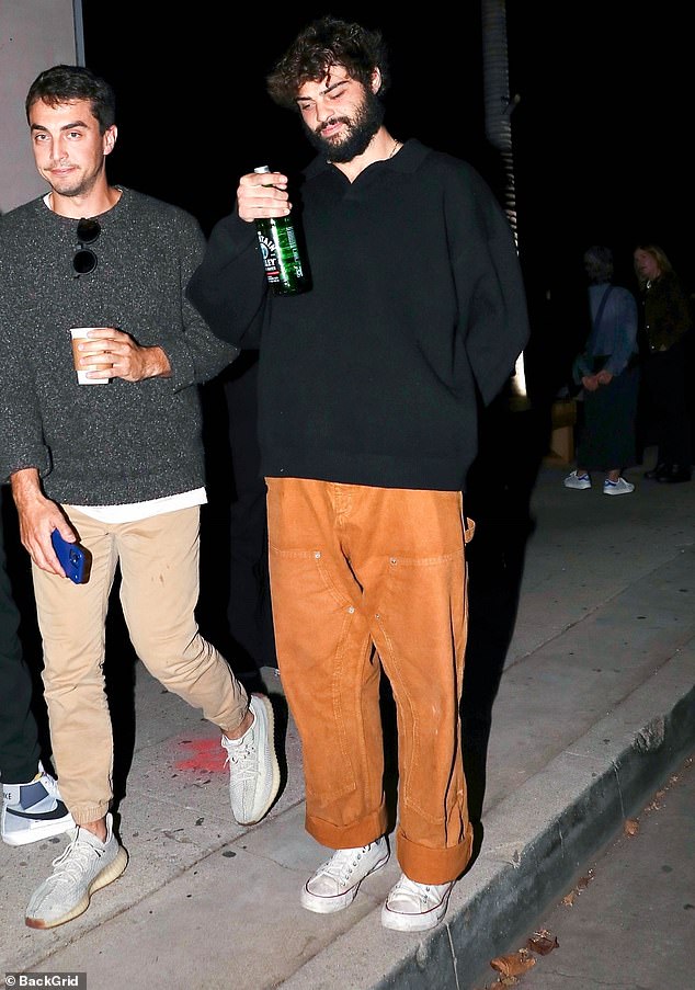 Boys' night out: The 6'0 Netflix star took a moment to pose with a glass bottle of water before heading to his next destination