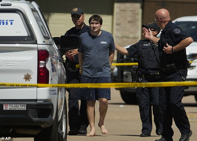 A man is taken away in handcuffs by Harris County Sheriff's Office deputies.  Authorities believe seven people were involved in the shooting, in which at least three people fired shots