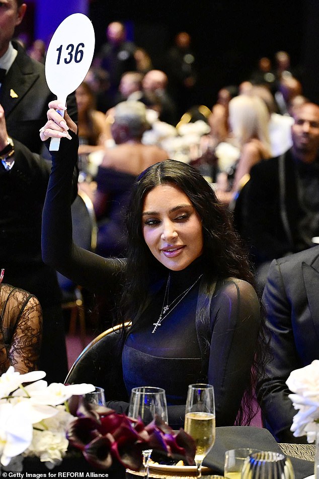 Have fun: Kim started the match with a flirty bid of $500,000.  Tom caught that pass, raised the bar and the back and forth began.  Witnesses say the two really got it on as they tried to hit on each other in a 'super fun and flirty' exchange