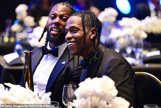 Have fun: Travis Scott showed off a rare smile as he took it easy with some of his friends