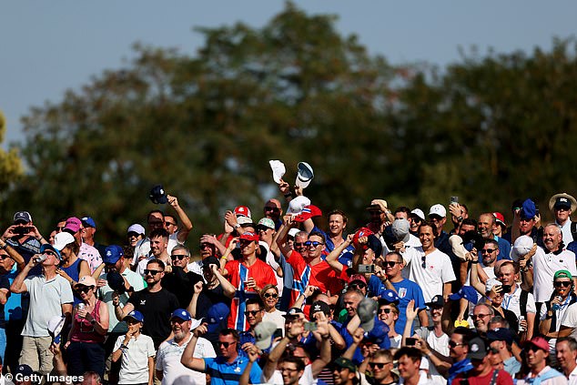 Fans wave their caps after reports that Cantlay refused to wear his hat in protest over not being paid