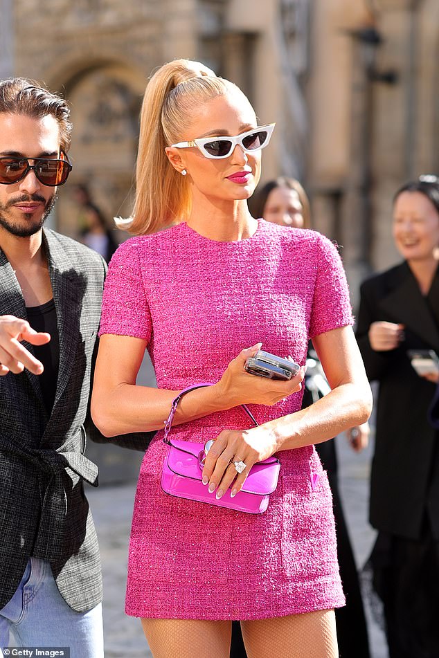 Incredibly, it was hard to miss her huge sparkling engagement ring when she arrived for the catwalk show