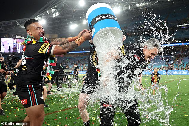 Ivan Cleary was given the traditional dip after his team won their third consecutive premiership - before turning up with a beer in hand at 6am on Monday