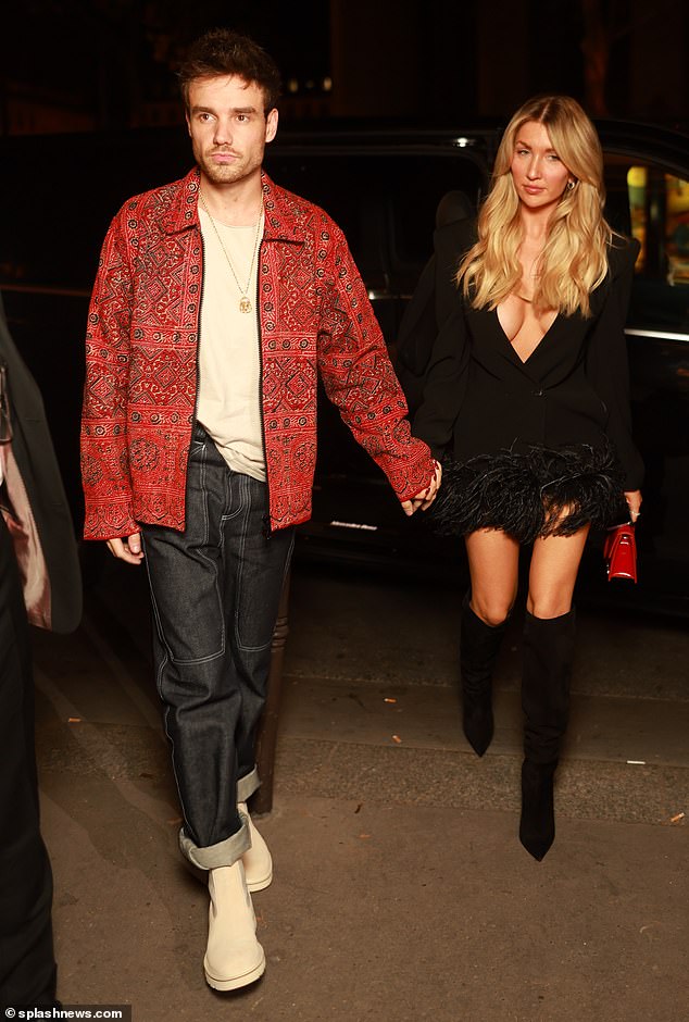 Stunning: Stepping out for the Frame dinner during Paris Fashion Week, Kate put on a busty show in a plunging black feather dress and tall boots