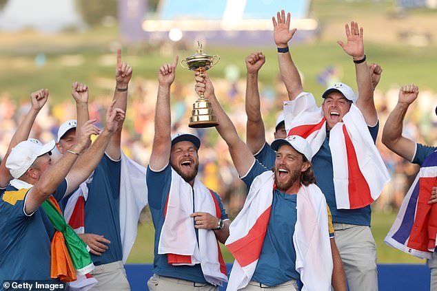 Team Europe's Tommy Fleetwood takes the Ryder Cup trophy after winning with a 16 and a half to 11 and a half victory