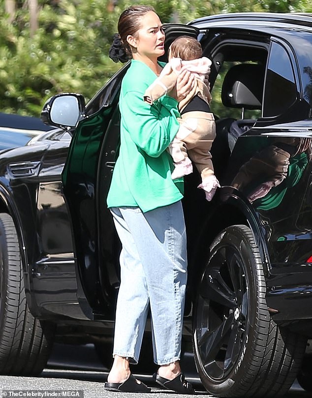 Completing the look: the entrepreneur wore large sunglasses and held a large bag over her left shoulder