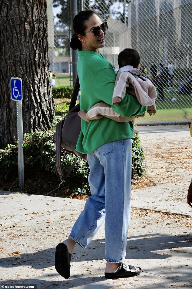 Beautiful: Her beautiful brunette locks were left tied in a loose bun as she enjoyed the company of her children