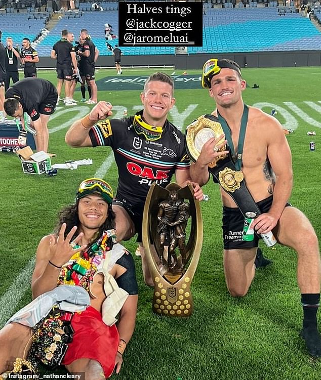 Nathan Cleary posed with his teammates, the Provan-Summons Trophy and the wrestling belt the team had made for the final