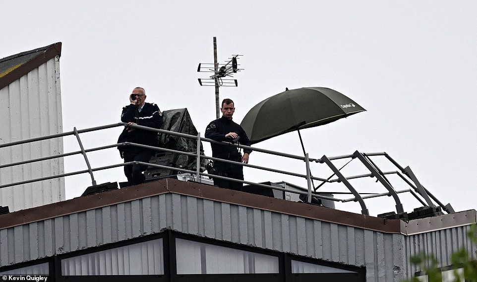 On a roof in the camp, snipers are in position, apparently watching out for drones that could convey tactics to opponents