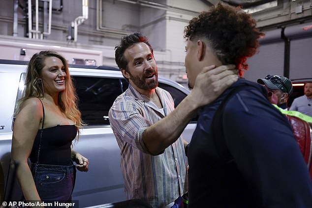 Hug: The couple of 11 years later shared a candid moment with Kansas City Chiefs quarterback Patrick Mahomes (R) in the arena parking garage