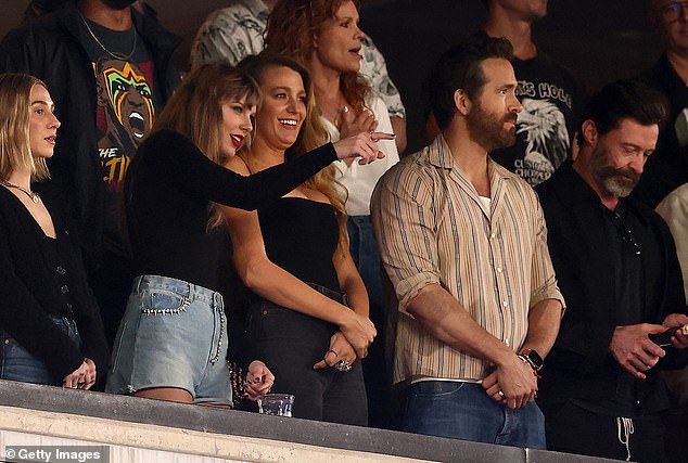 Special evening: The Grammy winner spoke with Blake, who stood next to Ryan, and Hugh Jackman (far right)