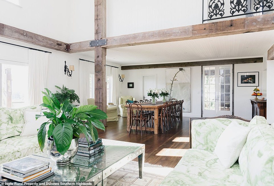 Through the vine-covered doors, guests are greeted with a small entrance leading to the open-plan dining room and lounge with high vaulted ceilings, wooden beams and iron lacework lining the mezzanine floor above.