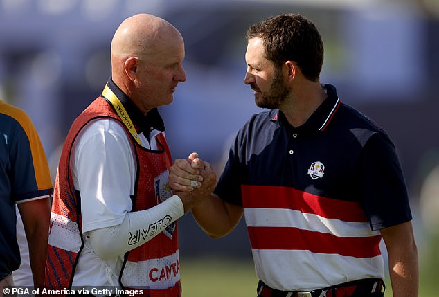 It was claimed he refused to wear a hat at the Ryder Cup in protest over a lack of pay, with his caddy Joe LeCava (left) involved in a feud with Rory McIlroy