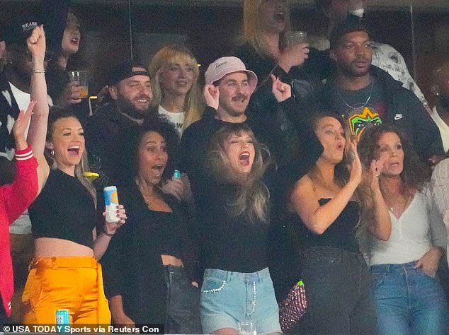 Taylor Swift raises her hands during the game at MetLife Stadium while watching Travis Kelche play