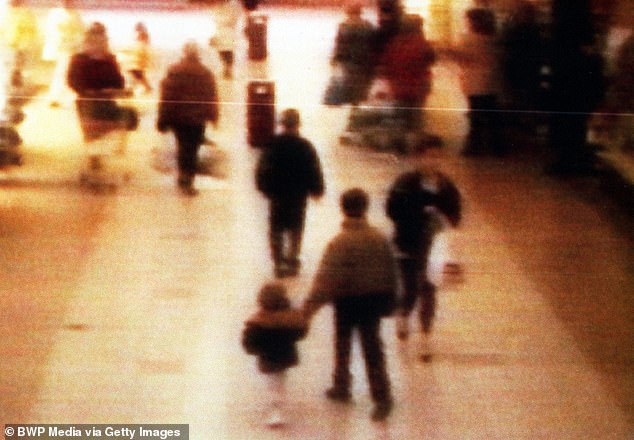 The now infamous image of James Bulger being led away from Bootle Strand shopping center by Jon Venables and Robert Thompson on February 12, 1993