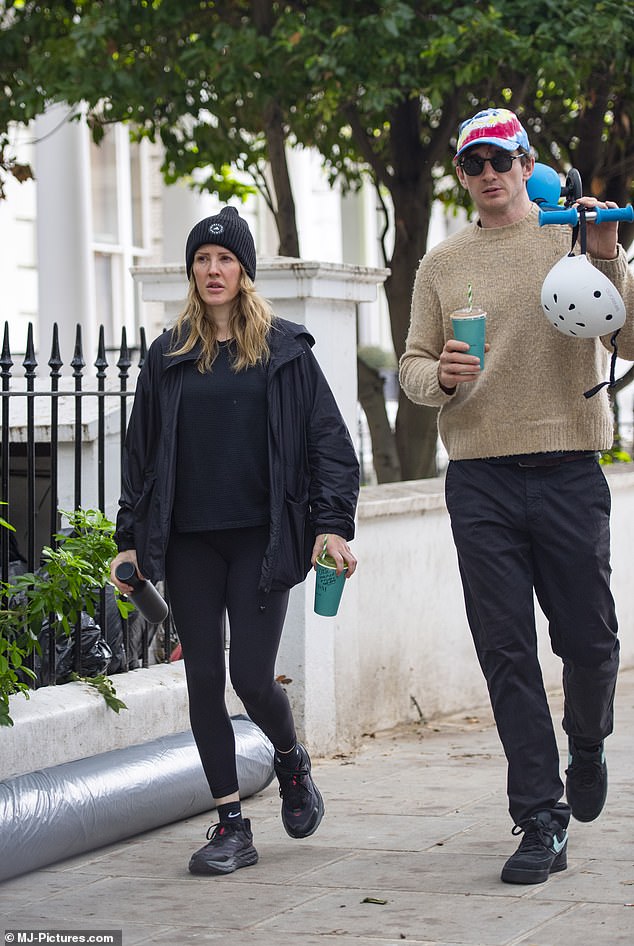 Getting Out: During their latest outing, Ellie and Caspar, who share son Arthur, held two juices while the latter held a child's scooter and helmet