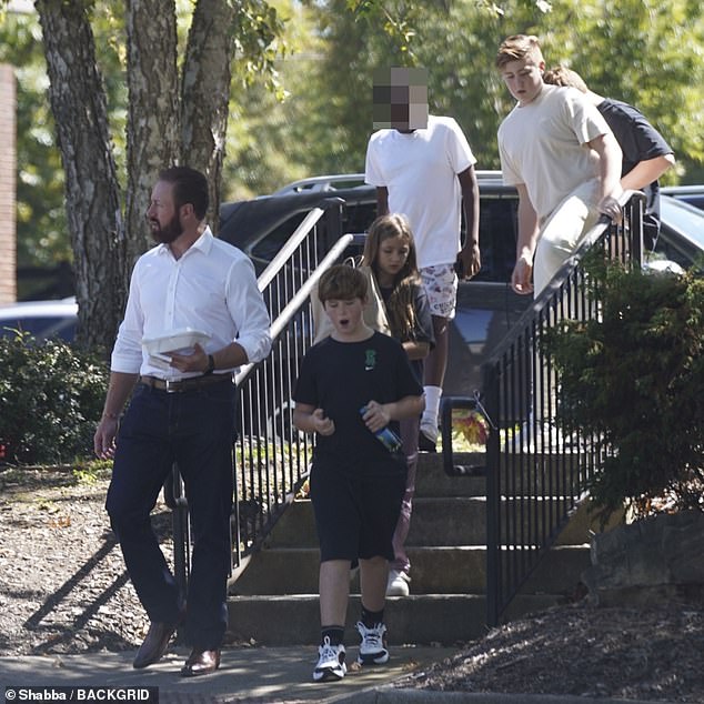 Family: He wore a white shirt and blue chinos while carrying some food as he walked with the couple's four children: KJ, 12, Kash, 11, and twins Kaia and Kane, nine.  Kroy also adopted Kim's daughters from her previous relationships, Brielle, 26, and Ariana, 21.