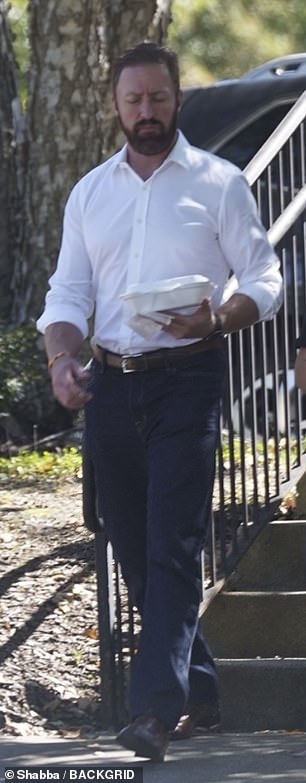 Brave: Kroy looked dapper in a shirt and chinos as he walked in the sun