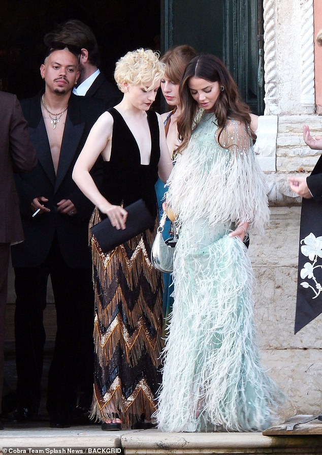 Wow: The actress posed for photos next to Miles Teller's wife Keleigh Sperry, 30, who stole the show in a glamorous turquoise dress with feathers