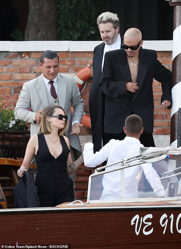 Trendy: Cara was followed in the water taxi by Evan Ross , who looked fashionable in an oversized black blazer