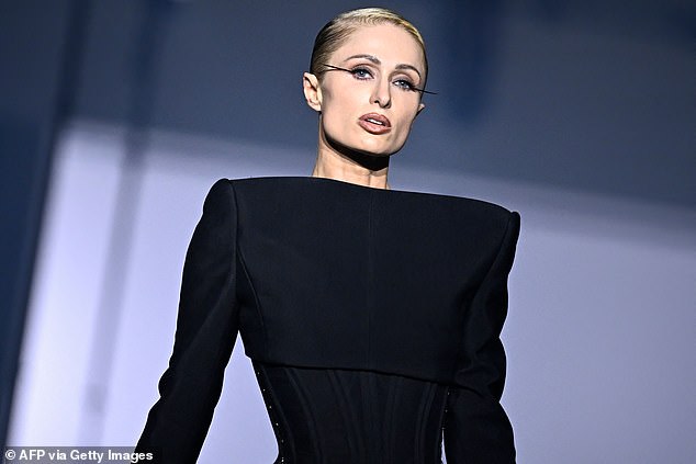 Stunning: On the runway, Paris wore dramatic black eye makeup and wore her blonde locks slicked back