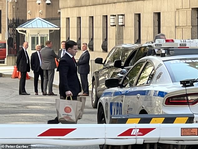 Suited staff were spotted carrying the brown paper bags into the Center Street complex after the former president listened to prosecutors accuse him of decades of 'lies' about his business empire