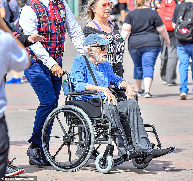 Theme park: The Mary Poppins star wore a blue sweater, sweatpants and a baseball cap, teaming it with sunglasses for his day out