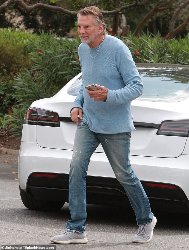 Relaxed: The Grammy winner looked relaxed in a light blue sweater and jeans as he left the deli