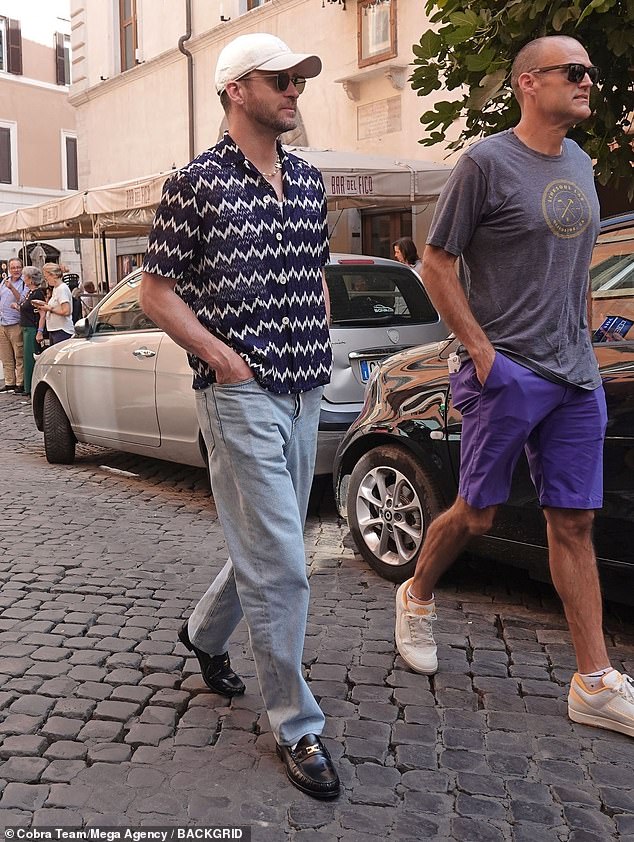 In sync: the actor and singer turned the streets of Rome into his catwalk as he strolled past the Bar del Fico