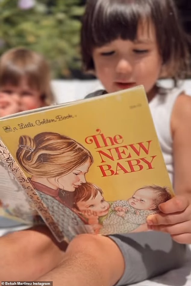 Siblings: In the short clip, her two eldest children were seen sitting close to the newborn as they read a book titled The New Baby in the warm sunshine.