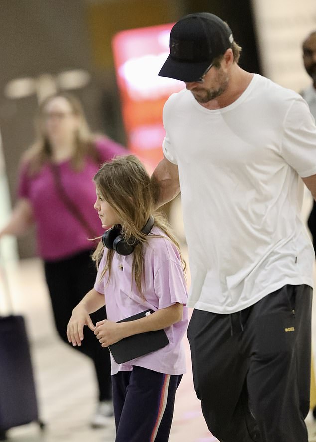 He put his arm around his daughter as they left the airport and walked to a waiting car