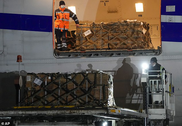 Workers unload a shipment of military aid delivered as part of United States security assistance to Ukraine at Boryspil Airport, outside Kiev, Ukraine, in early 2022