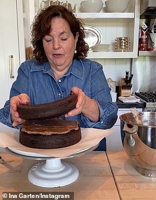 She turns the second layer of the cake upside down to create a flat top that looks 