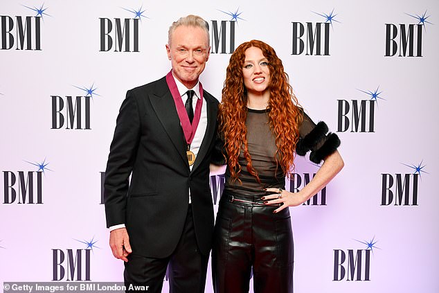 Friends: Jess looked happy and relaxed as she beamed for photos alongside musician Gary Kemp, 63, who won a BMI Icon award