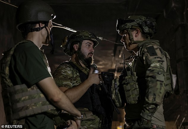 Ukrainian soldiers of the Spartan Brigade of the National Guard of Ukraine stand in a shelter on the front line, amid the Russian attack on Ukraine, in Zaporizhia, September 13