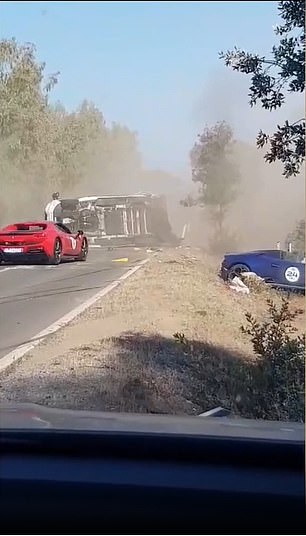 But seconds later the red Ferrari behind it can be seen trying to overtake at the same time, causing the Lamborghini to end up underneath the camper, which is then violently tipped on its side.