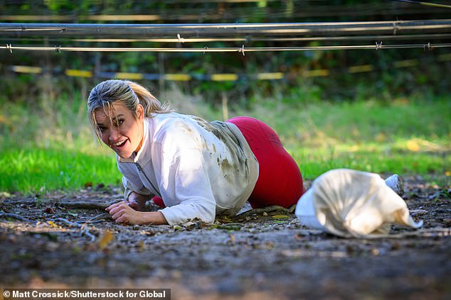 Hard work: Ashley got stuck in the mud while racing against the clock