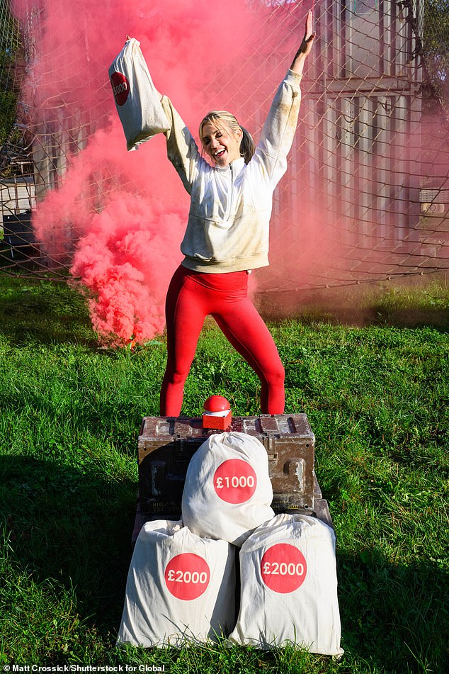 Good luck!  She held up bags of money as she posed in front of a red buzzer at the finish line