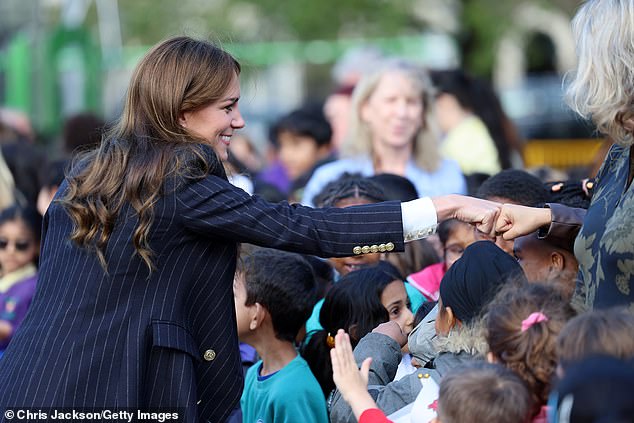 A royal fist bump: The Princess of Wales smiled as she ditched the traditional handshake and greeted a young royal fan in a different way